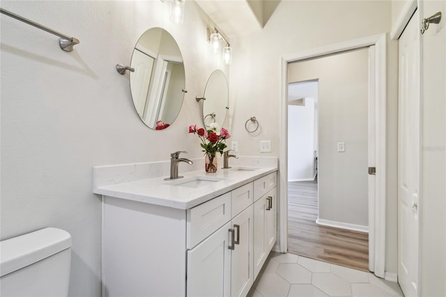 bathroom with vanity, toilet, and tile patterned flooring