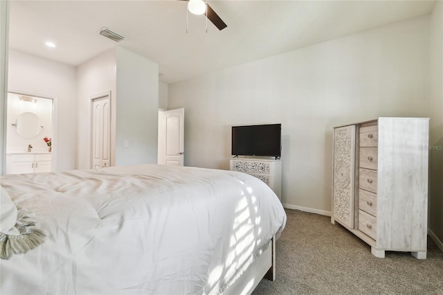 carpeted bedroom with ceiling fan and ensuite bath