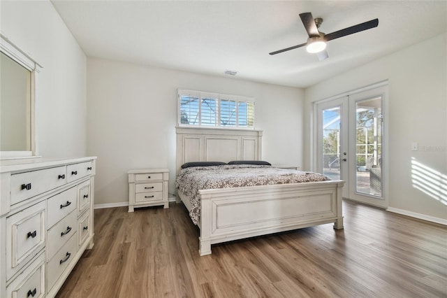 bedroom with hardwood / wood-style flooring, ceiling fan, access to exterior, and french doors