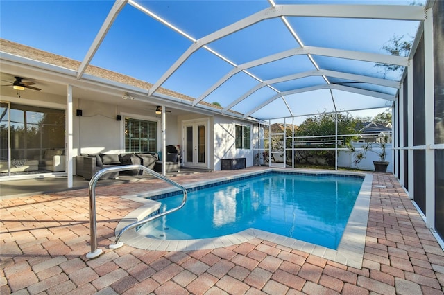 view of pool featuring a lanai, a patio, and ceiling fan