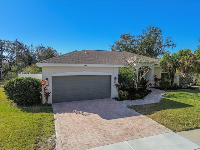 ranch-style house with a garage and a front yard