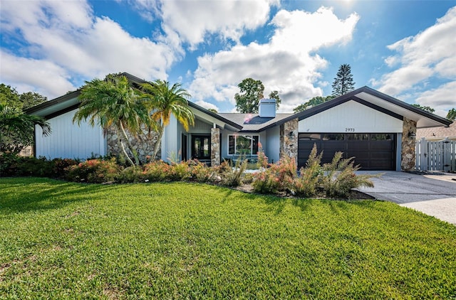 view of front facade with a garage and a front yard