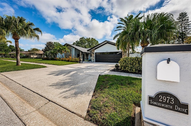 view of front of home featuring a garage and a front lawn