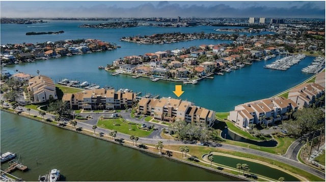 birds eye view of property with a water view and a residential view