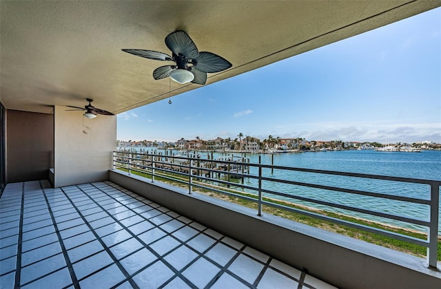 balcony with ceiling fan and a water view