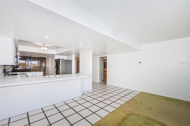 interior space featuring recessed lighting, visible vents, a sink, and light carpet