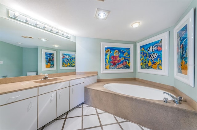 bathroom with toilet, vanity, and a bath