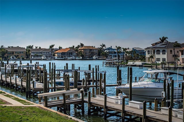 view of dock featuring a water view and a residential view