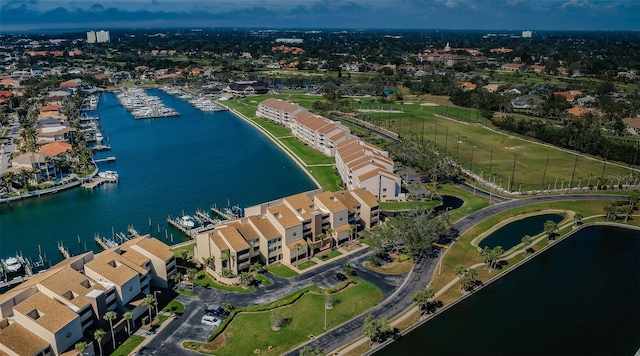 drone / aerial view with a residential view and a water view