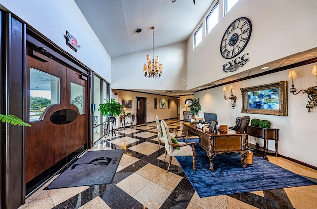 office area with a notable chandelier, a towering ceiling, and baseboards