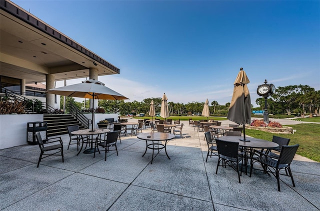 view of patio with outdoor dining space and stairway