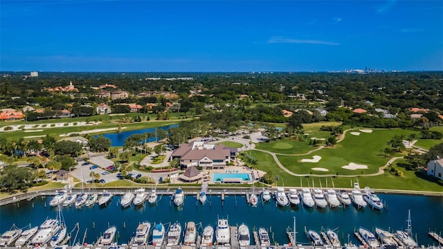 drone / aerial view with a water view and golf course view