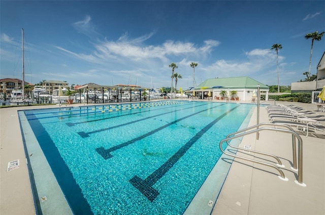 community pool featuring fence and a patio