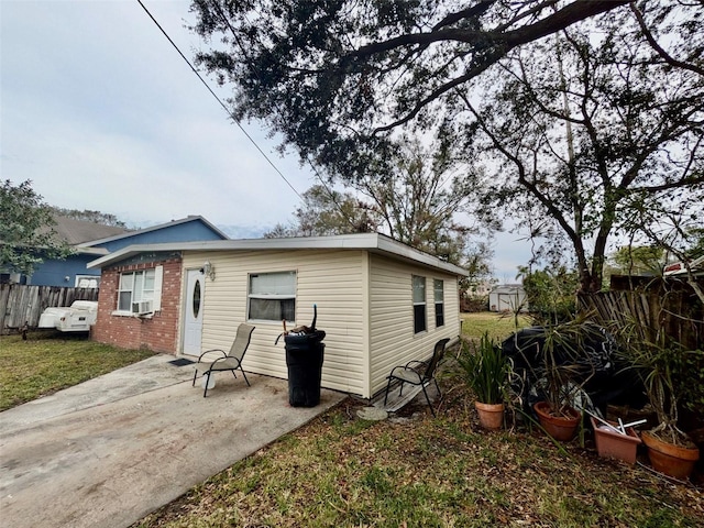 back of house featuring a lawn and a patio