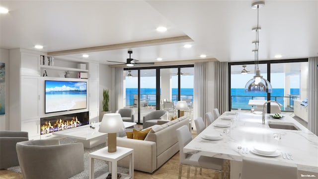 living room with ceiling fan, beam ceiling, sink, and light wood-type flooring