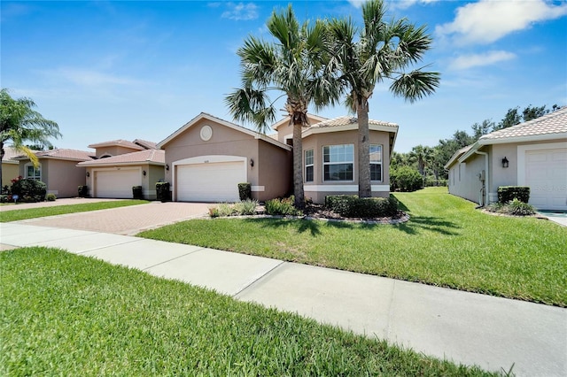 view of front of house with a garage and a front lawn