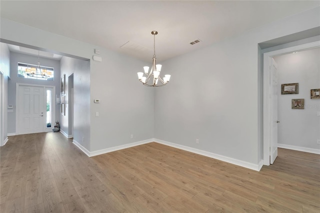 interior space with hardwood / wood-style flooring and a chandelier