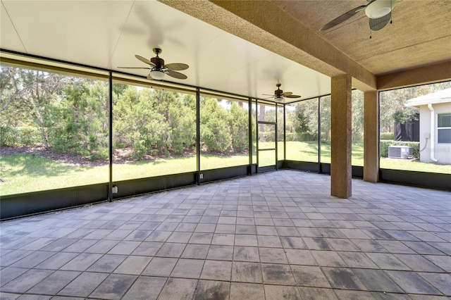 unfurnished sunroom with ceiling fan