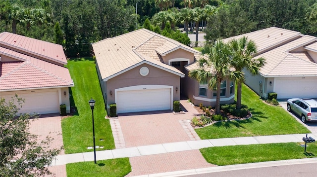 view of property featuring a garage and a front yard