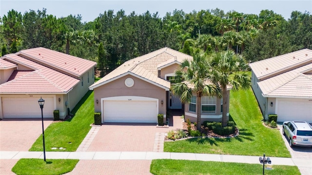 view of front of property with a garage and a front lawn