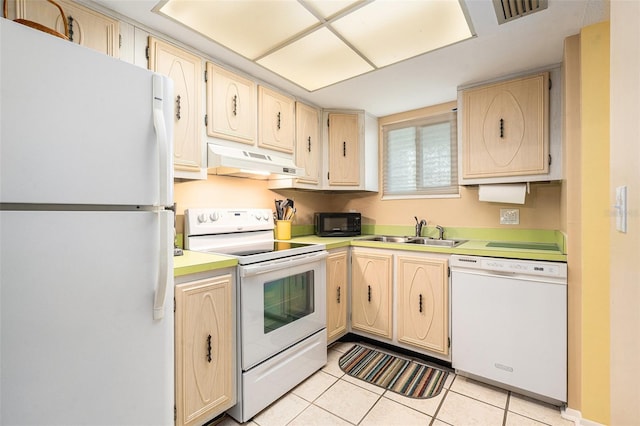 kitchen featuring white appliances, light brown cabinetry, sink, and light tile patterned floors