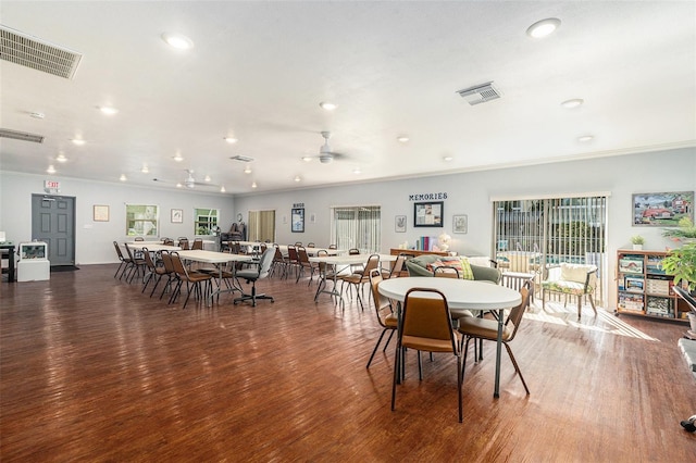 dining area featuring ceiling fan, ornamental molding, and dark hardwood / wood-style flooring