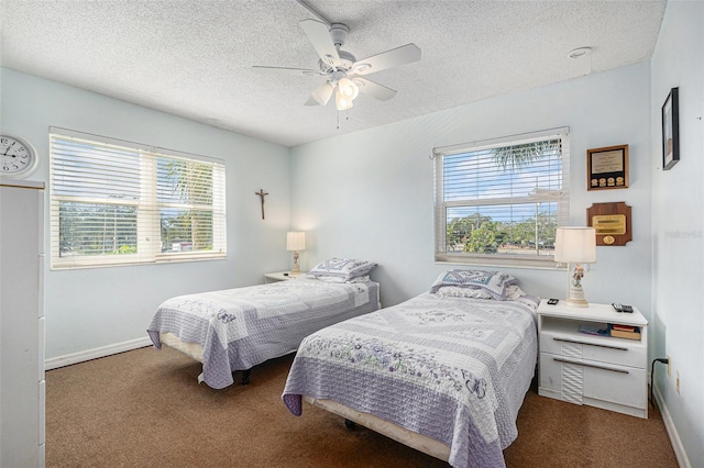 bedroom with ceiling fan, carpet floors, and a textured ceiling