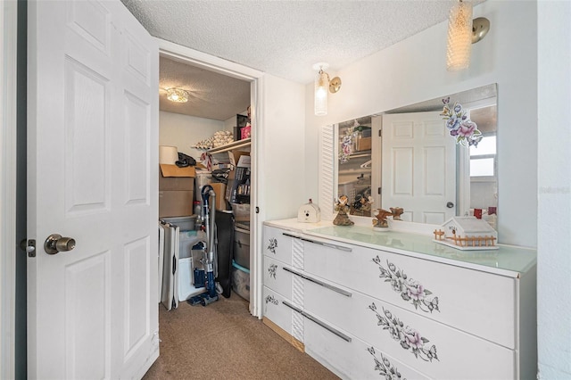 bathroom with vanity and a textured ceiling