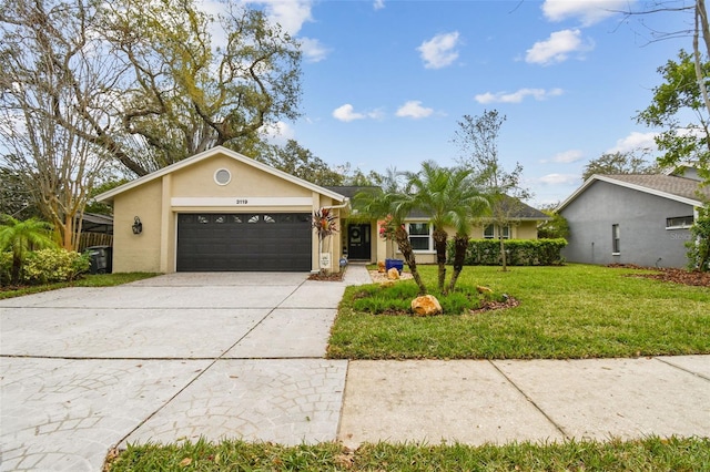 ranch-style home with a garage, concrete driveway, a front lawn, and stucco siding