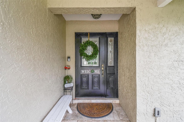 property entrance with stucco siding