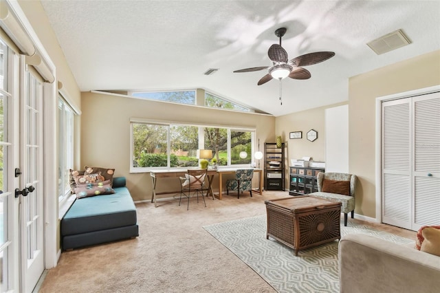 interior space with vaulted ceiling, a textured ceiling, light carpet, and visible vents