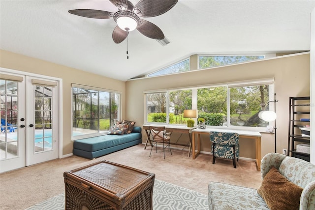 sunroom / solarium with ceiling fan, visible vents, vaulted ceiling, and french doors