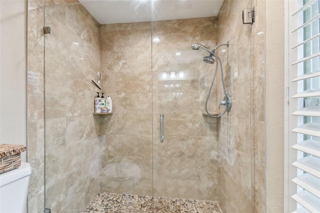 full bath with a stall shower and toilet