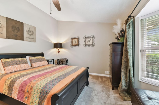 bedroom with light carpet, a ceiling fan, and baseboards