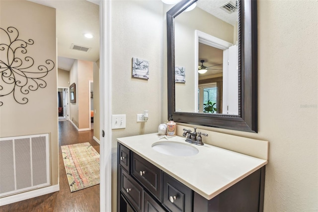 bathroom with visible vents, wood finished floors, and vanity