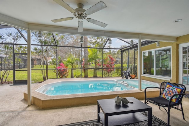 pool with a yard, glass enclosure, ceiling fan, and a patio