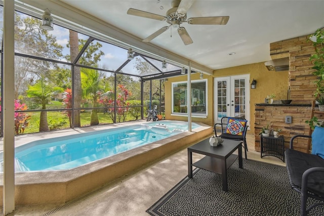 view of swimming pool with a pool with connected hot tub, a patio, and french doors