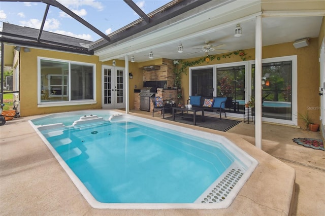 view of pool with ceiling fan, outdoor lounge area, french doors, grilling area, and a patio area