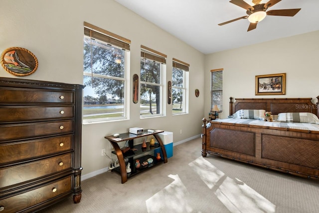 bedroom featuring light colored carpet and ceiling fan