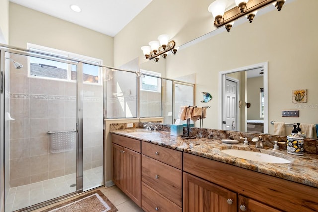 bathroom featuring an enclosed shower, vanity, a notable chandelier, and tile patterned floors