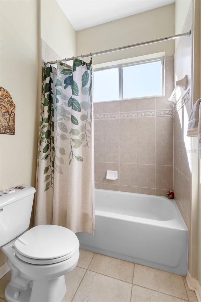 bathroom with tile patterned flooring, toilet, and shower / bath combo with shower curtain