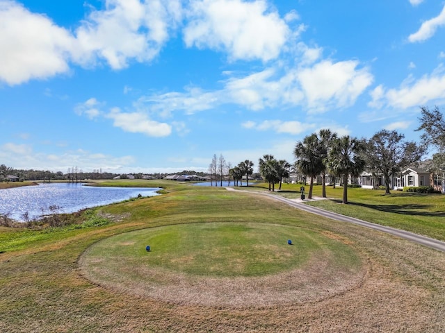 view of home's community featuring a water view and a lawn