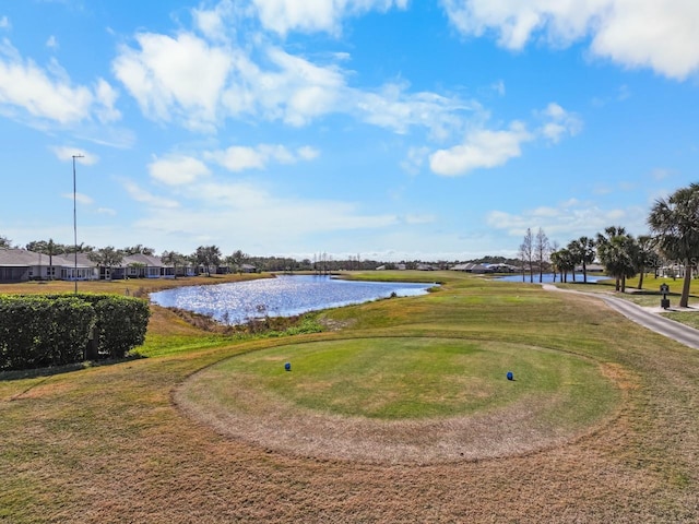 view of home's community with a lawn and a water view