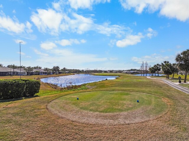 surrounding community featuring a water view and a yard