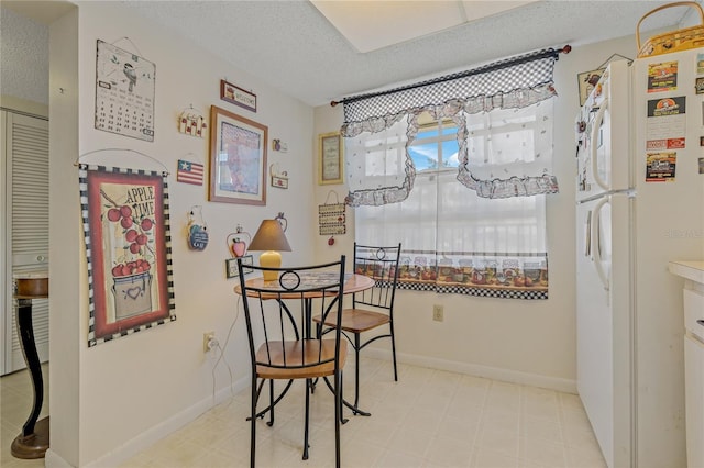 dining area with a textured ceiling