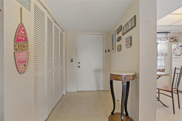 corridor featuring a textured ceiling