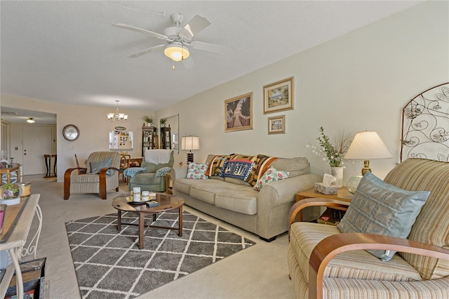 carpeted living room featuring ceiling fan with notable chandelier and a textured ceiling