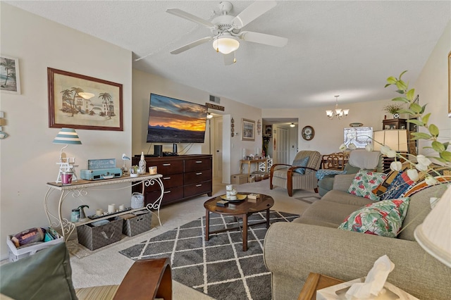 living room with ceiling fan with notable chandelier, carpet floors, and a textured ceiling