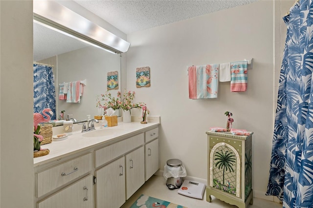 bathroom featuring vanity, a textured ceiling, and a shower with curtain