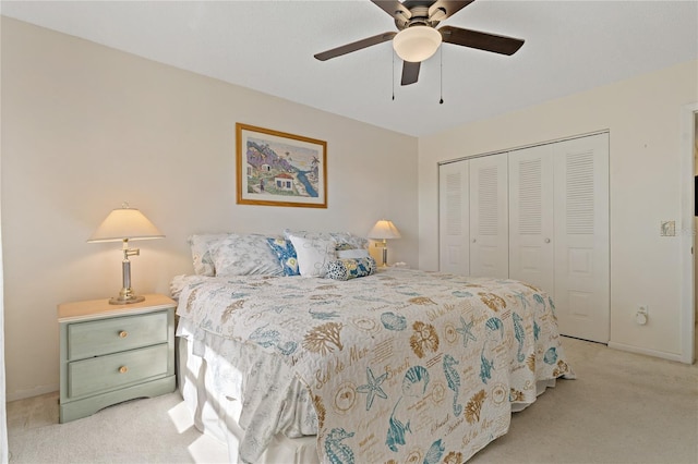 bedroom featuring ceiling fan, light colored carpet, and a closet